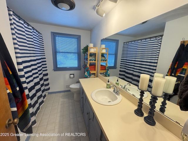 bathroom with tile patterned floors, vanity, and toilet