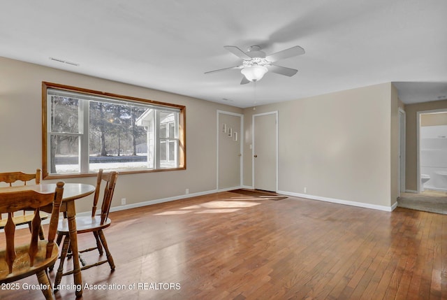 dining space featuring hardwood / wood-style flooring and ceiling fan