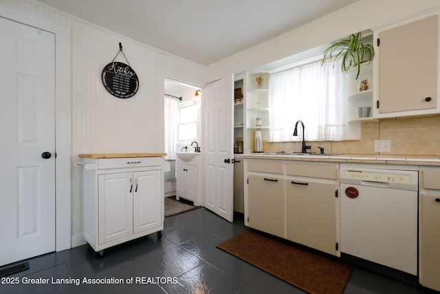 kitchen with a healthy amount of sunlight, dishwasher, and sink