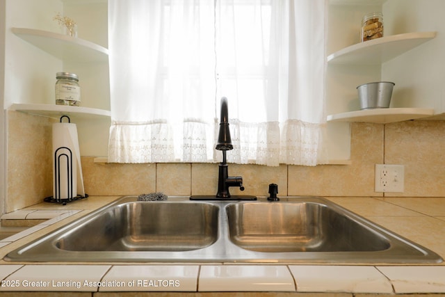 interior details featuring tasteful backsplash and sink