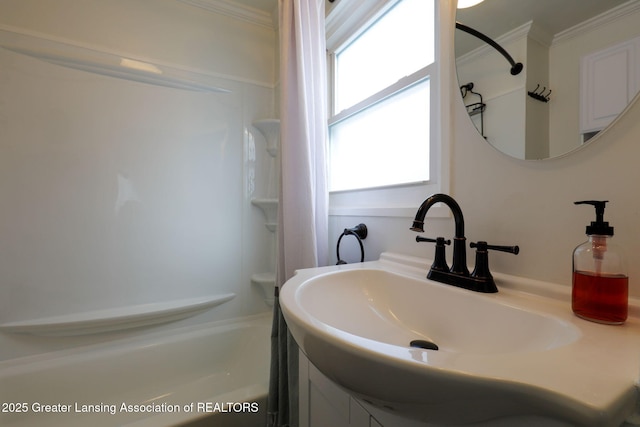 bathroom with crown molding, washtub / shower combination, and vanity