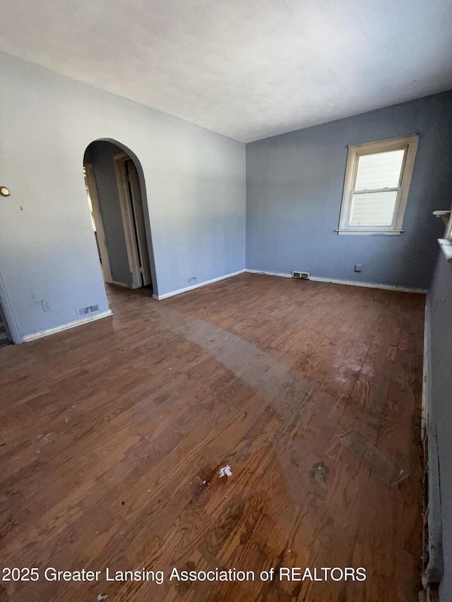 spare room with dark wood-type flooring