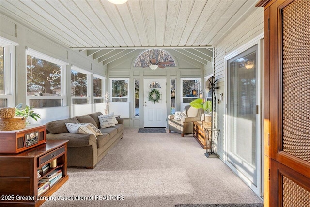 sunroom / solarium featuring vaulted ceiling and wood ceiling