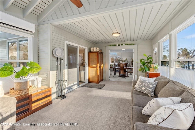 sunroom with plenty of natural light, beam ceiling, and a wall mounted AC