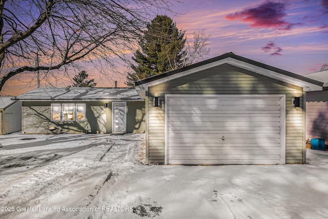 view of garage at dusk