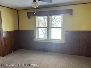 unfurnished room with wooden walls