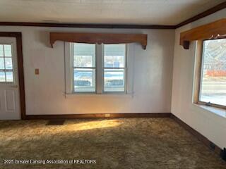 interior space with ornamental molding and carpet flooring