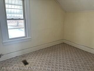 additional living space featuring vaulted ceiling