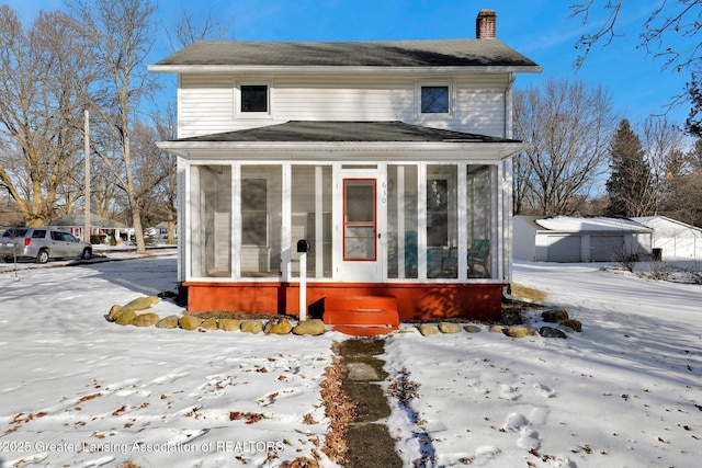 view of front of property featuring a sunroom