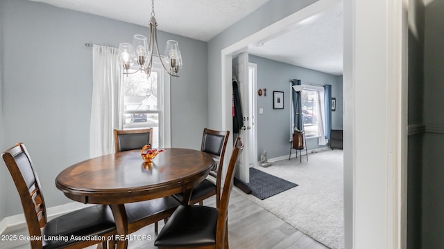 dining area featuring a chandelier and light hardwood / wood-style floors