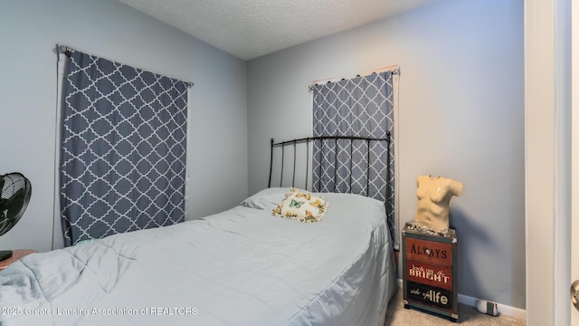 carpeted bedroom featuring a textured ceiling