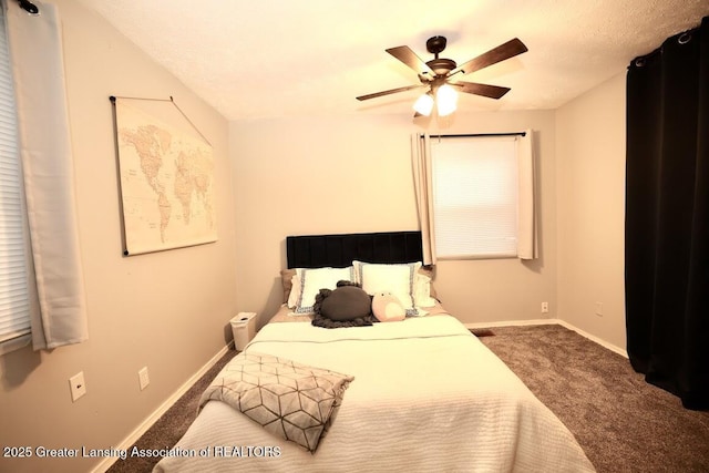 carpeted bedroom with a textured ceiling and ceiling fan