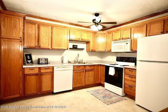 kitchen with sink, white appliances, and ceiling fan