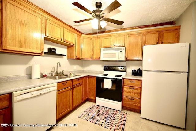 kitchen featuring sink, white appliances, light tile patterned floors, and ceiling fan