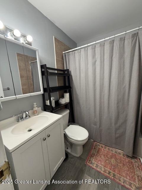 bathroom featuring vanity, hardwood / wood-style floors, and toilet