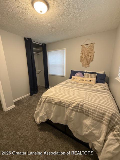 carpeted bedroom featuring a textured ceiling