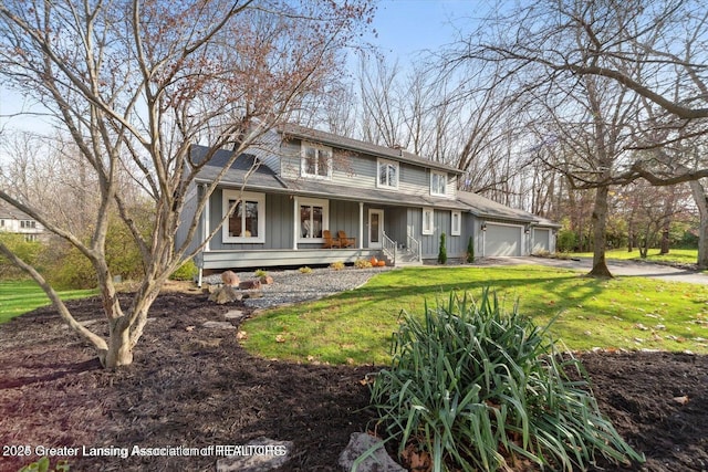 farmhouse inspired home with a garage, covered porch, and a front yard