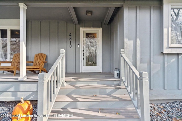 view of exterior entry featuring a porch