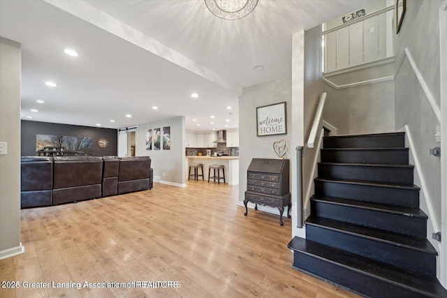 stairway featuring wood-type flooring and a barn door