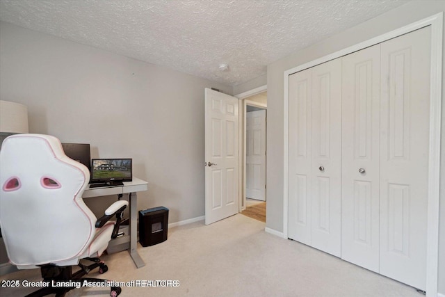 office featuring light colored carpet and a textured ceiling