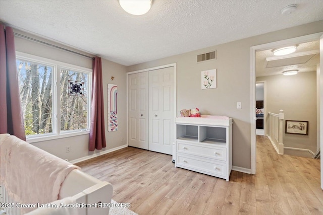 sitting room featuring a textured ceiling and light hardwood / wood-style floors