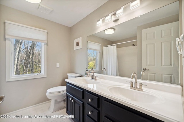 bathroom featuring tile patterned floors, vanity, toilet, and curtained shower