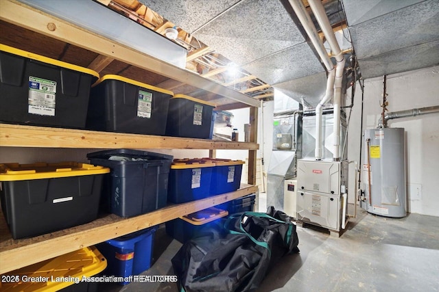 storage area featuring heating unit and gas water heater