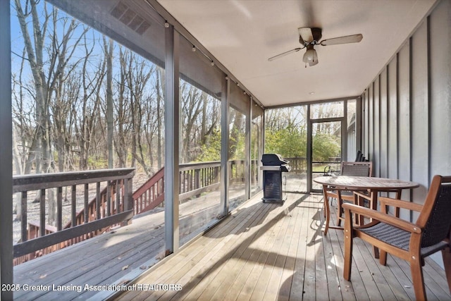 sunroom featuring ceiling fan