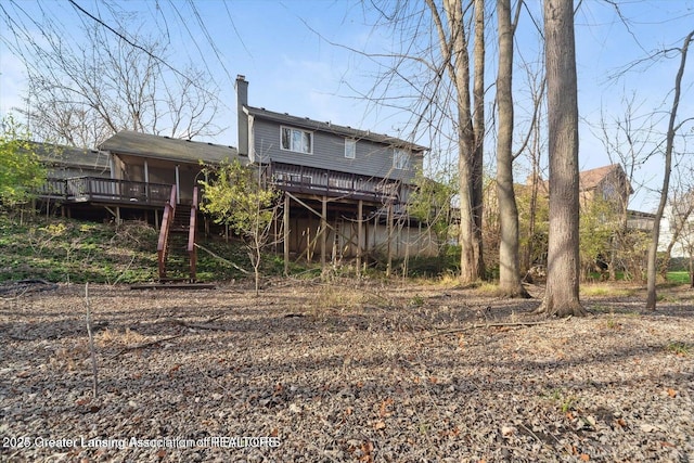 back of property featuring a wooden deck