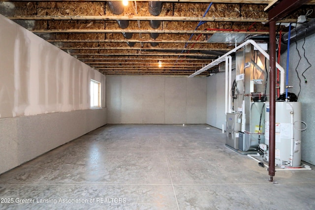 basement featuring heating unit and water heater