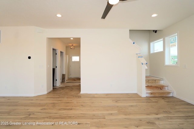 empty room with ceiling fan and light wood-type flooring