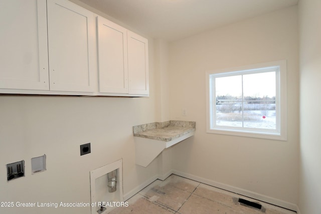 laundry room featuring cabinets and electric dryer hookup