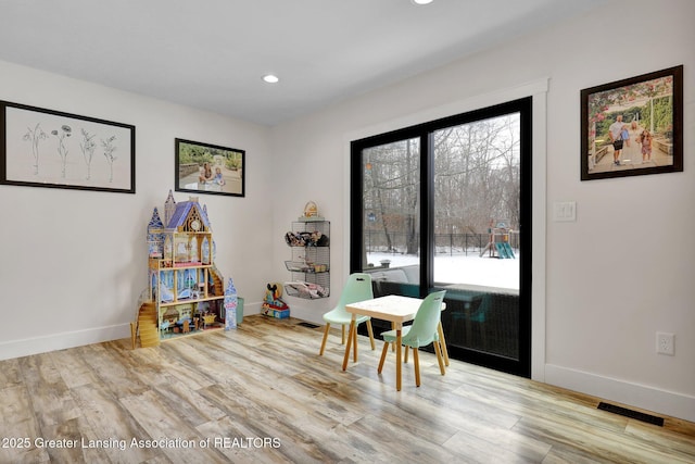 recreation room featuring a healthy amount of sunlight and light wood-type flooring