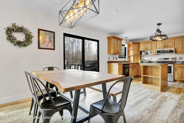 dining room with sink and light hardwood / wood-style floors