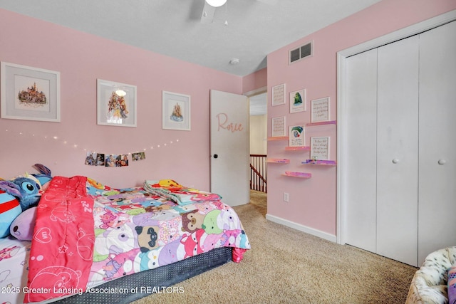 carpeted bedroom featuring ceiling fan and a closet