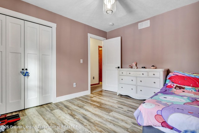 bedroom featuring a closet and light wood-type flooring