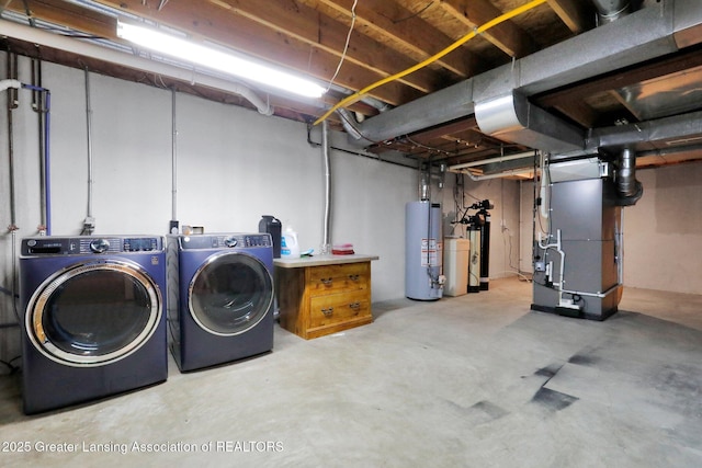 basement featuring separate washer and dryer, heating unit, and gas water heater