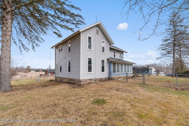 back of house with fence and a yard