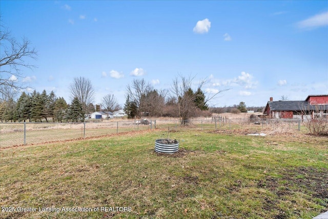 view of yard with a rural view and fence