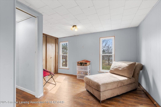 living area with baseboards and hardwood / wood-style floors