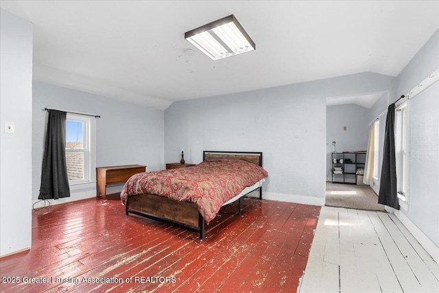 bedroom featuring lofted ceiling and wood-type flooring