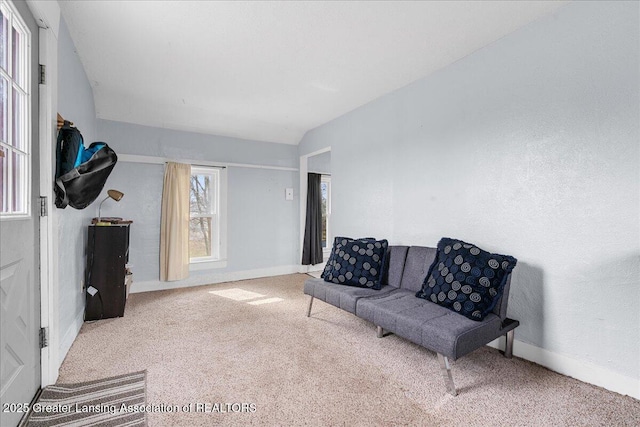 living room featuring carpet and baseboards