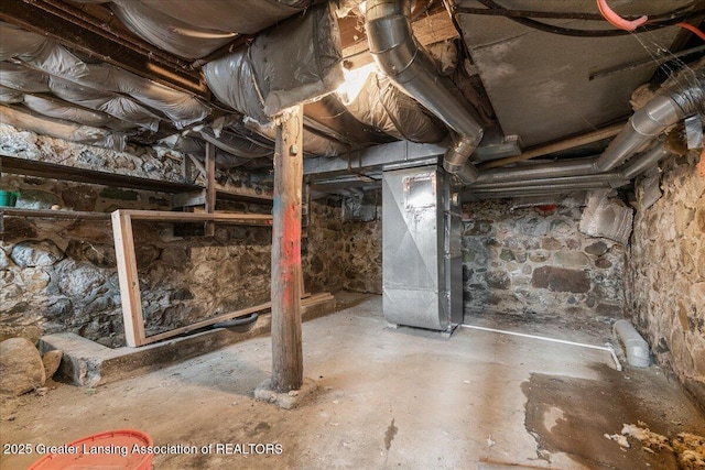 unfinished basement featuring heating unit