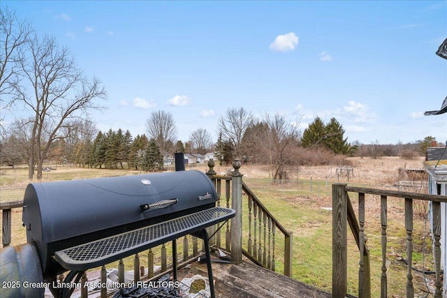 wooden deck with a grill and fence