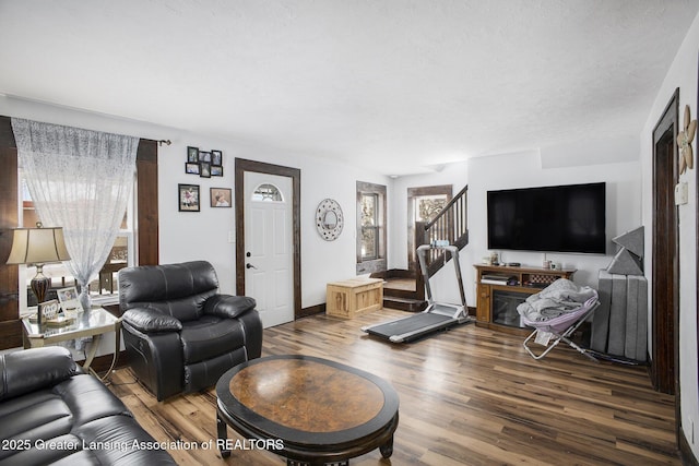 living room with hardwood / wood-style flooring and a textured ceiling