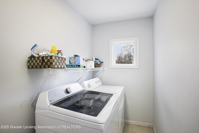 laundry room with tile patterned flooring and washer and clothes dryer