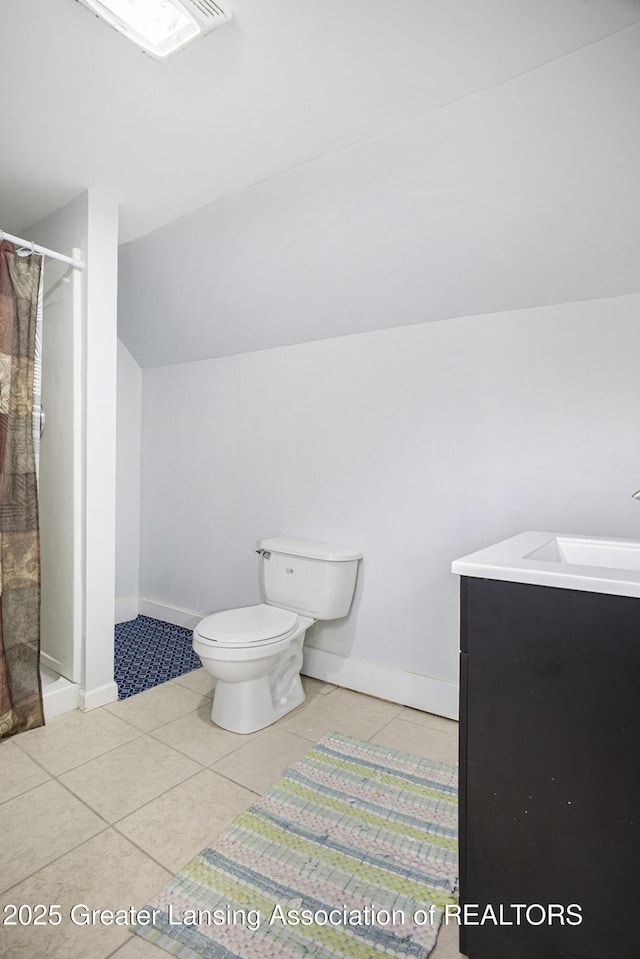 bathroom with lofted ceiling, tile patterned floors, toilet, a shower with curtain, and vanity