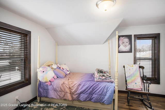 bedroom with vaulted ceiling and dark wood-type flooring