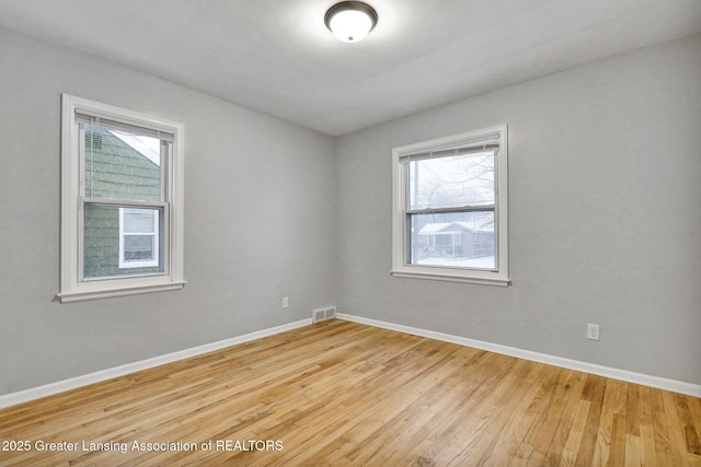 unfurnished room featuring hardwood / wood-style floors