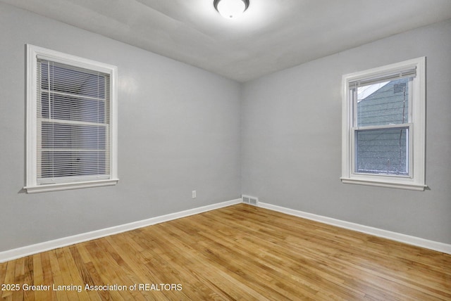 unfurnished room with wood-type flooring